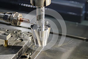 The close up scene the sinker EDM machine operation in the light blue scene