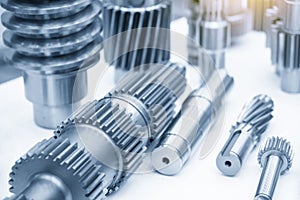 The close-up scene of various type of the pinion gear parts shaft in the light blue scene.