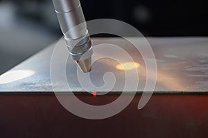 Close up scene the welding process by robotic system with red beam