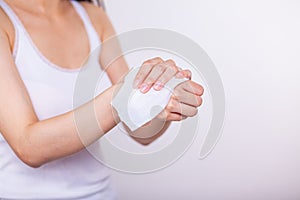 Close-up scene: Women cleaning hands with wet wipes