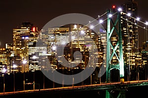 CLOSE UP: Scenic view of illuminated Vancouver skyline and a large bridge.