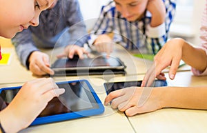 Close up of school kids playing with tablet pc