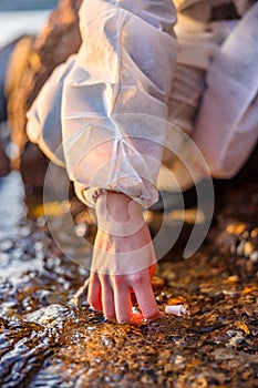 Close-up of scientist collecting water sample at seashore