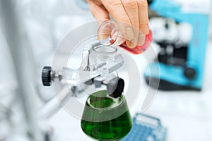 Close up of scientist filling test tubes in lab