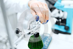 Close up of scientist filling test tubes in lab