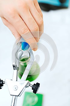 Close up of scientist filling test tubes in lab