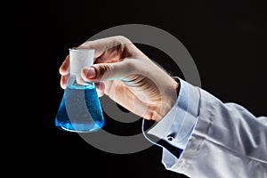Close up of scientist holding flask with chemical