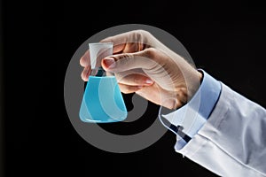 Close up of scientist holding flask with chemical