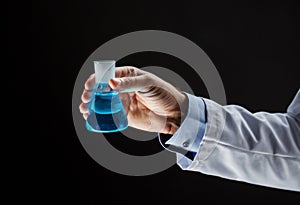 Close up of scientist holding flask with chemical