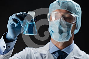 Close up of scientist holding flask with chemical