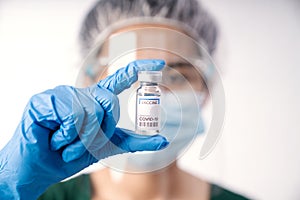 close up scientist holding vaccine coronavirus in lap