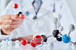 Scientist with coloured molecular structure models photo