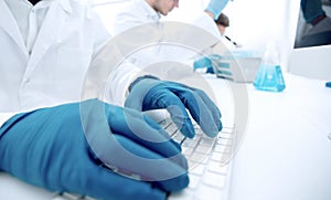 Close up.scientist typing on computer keyboard.