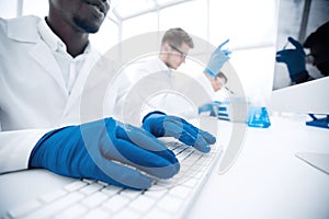 Close up.scientist typing on computer keyboard.