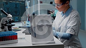 Close up of scientist using micropipette at laboratory desk