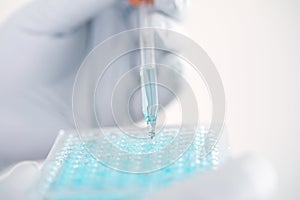 Close up a scientist working in laboratory to analyze blue extra