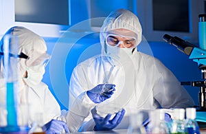 Close up of scientists with test samples in lab