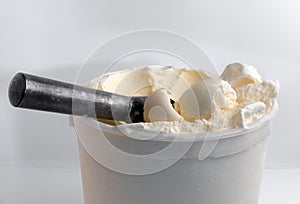 Close up Scoops of Vanilla Ice Cream with an ice cream scoop on a white background