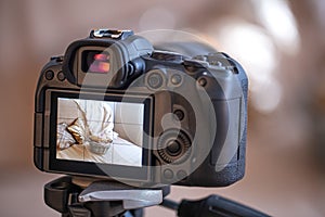 Close up of the screen of a professional digital camera on a tripod while shooting a home composition