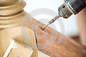 Close up screwdriver auto machine is screwing the nut in to the wood. image for background