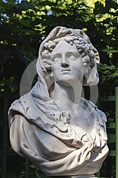 Close-up of sculpture woman\'s head made of white marble. Old statue of sensual sad woman in veil