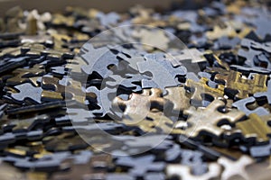 Close-up of a sea of jigsaw puzzles inside a box