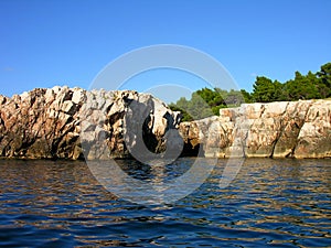 Close-up seagull seaside. close-up photohigh rocks by the sea and the cave that can be entered through.