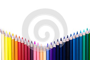 Close up seamless colored pencils row with wave on lower side isolated on white background.