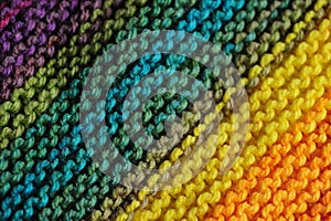 Close up of seamless knitted patterns in rainbow mixed colors with primary green and blue