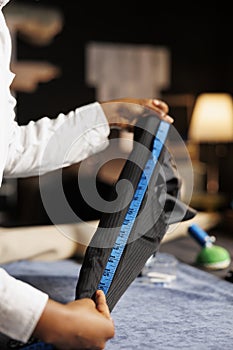 Close up of seamstress measuring garment