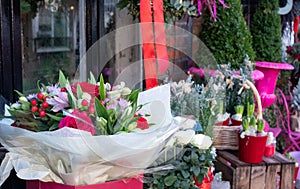 Close up of seasonal potted plants and flowers on sale at florist shop in December. Photographed pre-Christmas in Surrey, UK.