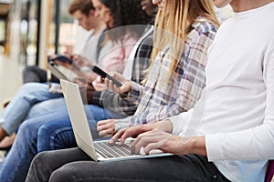 Close Up Of Seated College Students Using Digital Technology