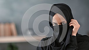 Close up secrecy Turkish lady hiding face under niqab having traditional Muslim privacy posing