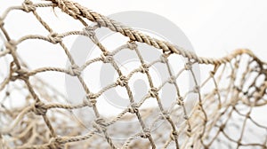 Close-up of a section of beige fishing net, knotted and interwoven