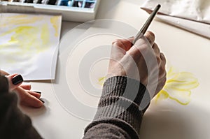 Close up section of female painter artist hand leading brush. Woman painting a picture