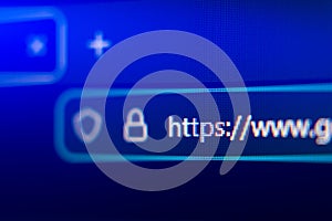 Close-up of a secure web browser address bar with HTTPS protocol, padlock icon, and shield symbol, representing internet