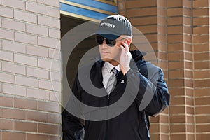 Young Security Guard Standing In Front Of The Entrance