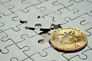 Close up a select focus gold bitcoin and Final piece of jigsaw puzzle.