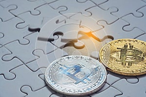 Close up a select focus gold and silver bitcoin and Final piece of jigsaw puzzle.