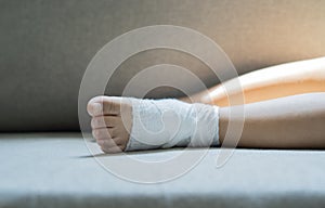 Close-up and selective focus of child ankle joint pain with bandage gauze as