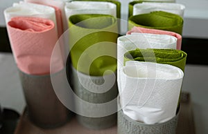Close up and selective focus with copy space shot of colorful paper napkins folded in many cup containers prepared for restaurant