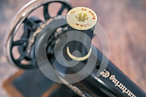 Spool of black cotton on a hand sewing machine