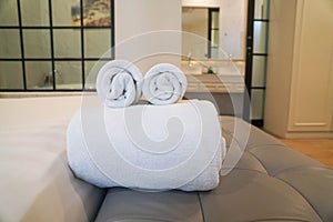 close up selective focus soft neat white towels in the hotel luxury bedroom