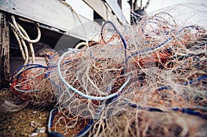 Close up and selective focus,traditional fishing net over blurred background and wooden fisherman cottage