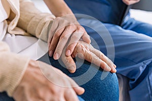 Close-up senior Asian woman hand with her caregiver helping hands, Caregiver visit at home. Home health care and nursing home