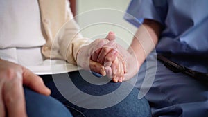 Close-up senior Asian woman hand with her caregiver helping hands, Caregiver visit at home. Home health care and nursing home