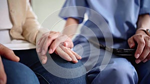 Close-up senior Asian woman hand with her caregiver helping hands, Caregiver visit at home. Home health care and nursing home