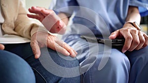 Close-up senior Asian woman hand with her caregiver helping hands, Caregiver visit at home. Home health care and nursing home