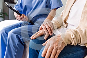 Close-up senior Asian woman hand with her caregiver helping hands, Caregiver visit at home. Home health care and nursing home