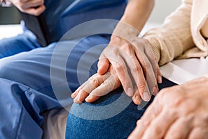 Close-up senior Asian woman hand with her caregiver helping hands, Caregiver visit at home. Home health care and nursing home